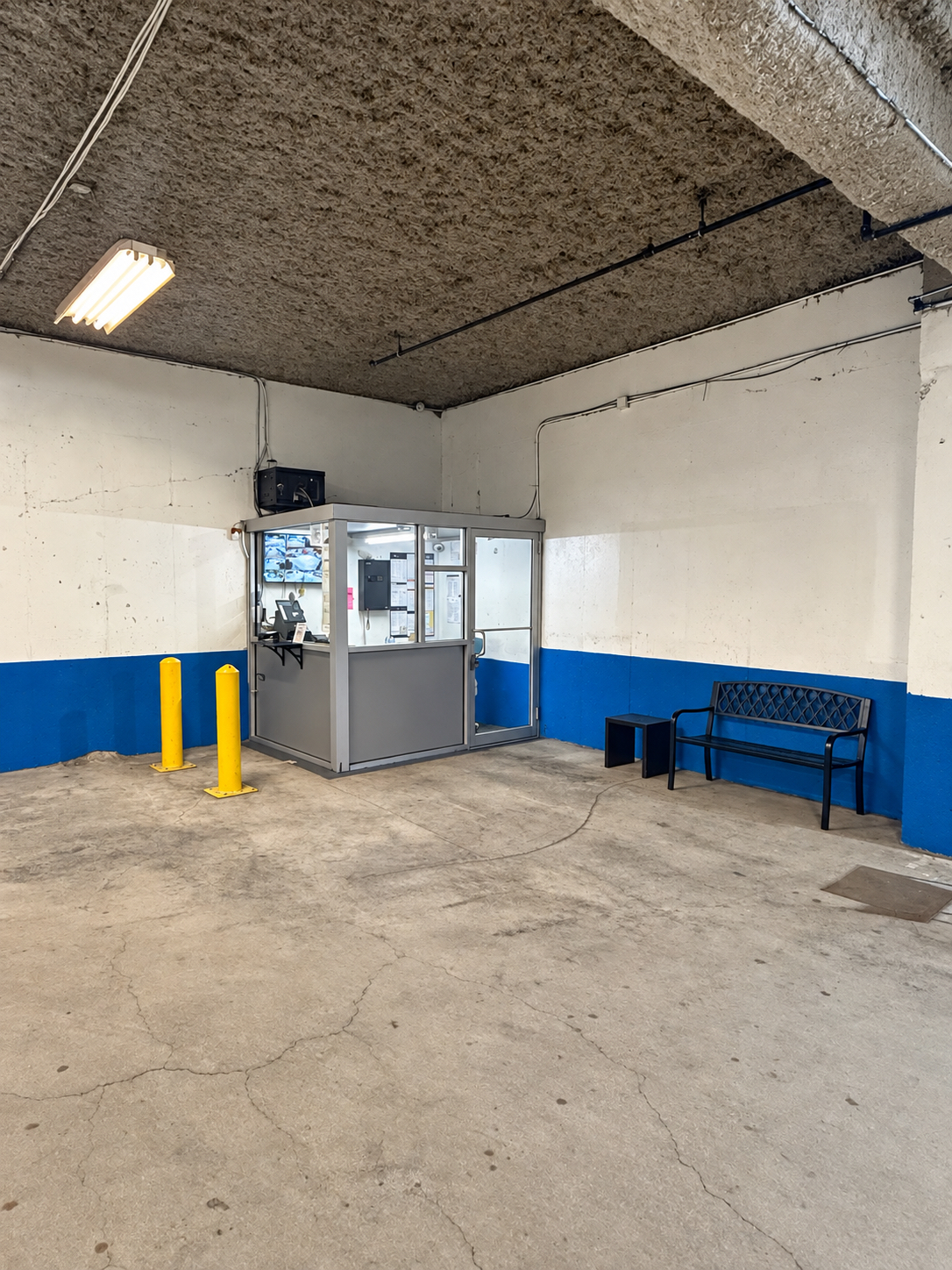 Attendant booth and waiting bench inside the garage at 125 Metropolitan Avenue