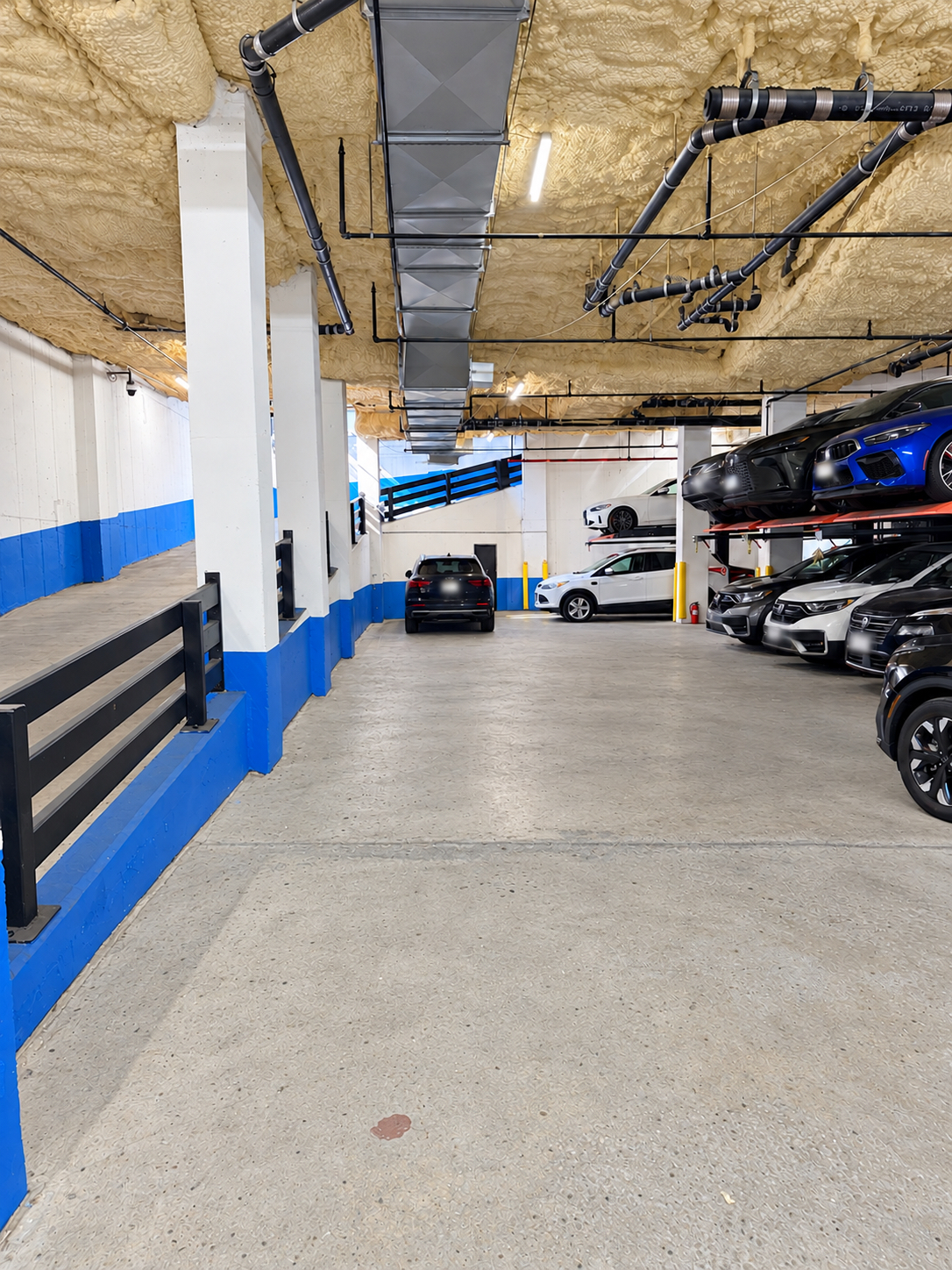Interior drive aisle beside vehicle lifts and entrance ramp at 222 Johnson Avenue