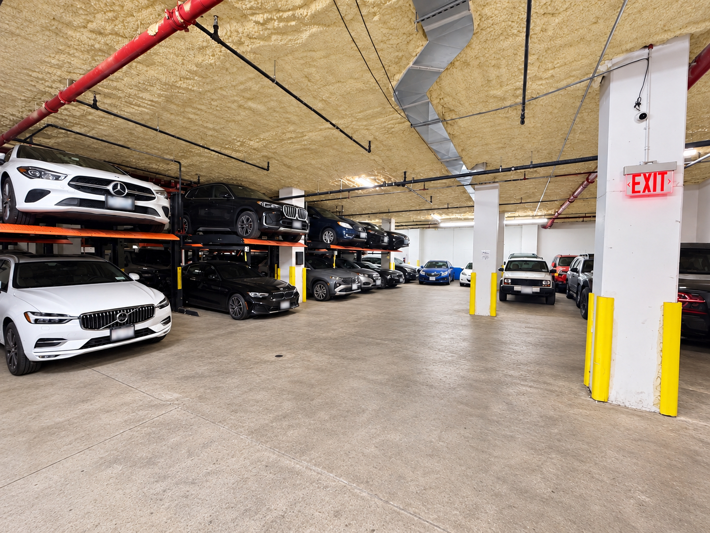 Parking spaces and vehicle lifts inside the garage at 222 Johnson Avenue