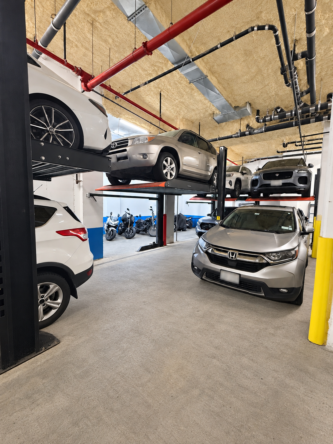 Vehicles parked on lifts inside the garage at 222 Johnson Avenue